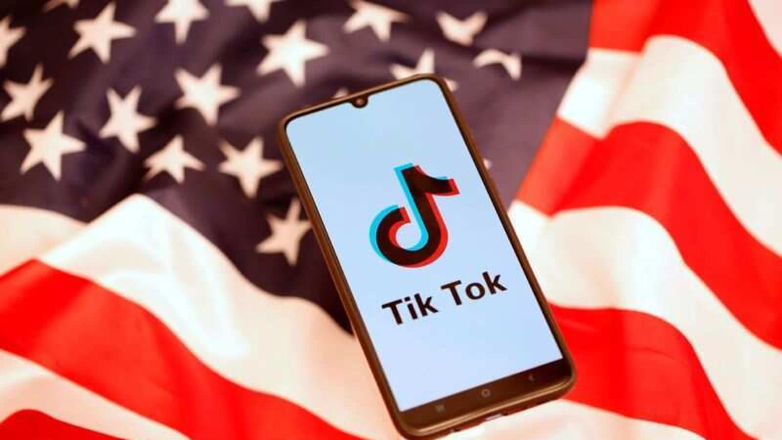 TikTok logo is displayed on the smartphone while standing on the US flag. REUTERS/Dado Ruvic/Files