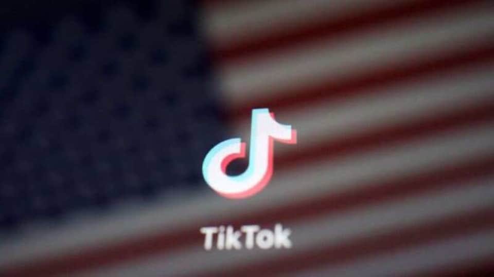 FILE PHOTO: A reflection of the U.S. flag is seen on the sign of the TikTok app in this illustration picture taken September 19, 2020. REUTERS/Florence Lo/Illustration