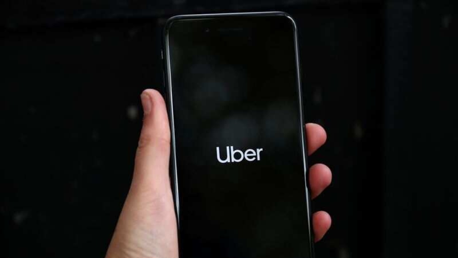 FILE PHOTO: Uber's logo is displayed on a mobile phone in London, Britain, September 14, 2018. REUTERS/Hannah Mckay