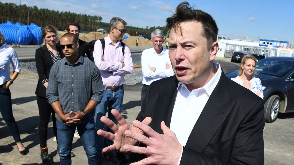 Technology entrepreneur Elon Musk talks to media as he arrives the Tesla Gigafactory construction site for a visit in Gruenheide near Berlin, Germany, Sept. 3, 2020.