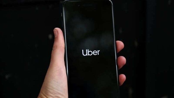 Uber's logo is displayed on a mobile phone in London, Britain.