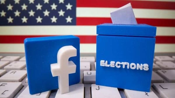 FILE PHOTO: A 3D-printed elections box and Facebook logo are placed on a keyboard in front of U.S. flag in this illustration taken October 6, 2020. REUTERS/Dado Ruvic/Illustration/File Photo