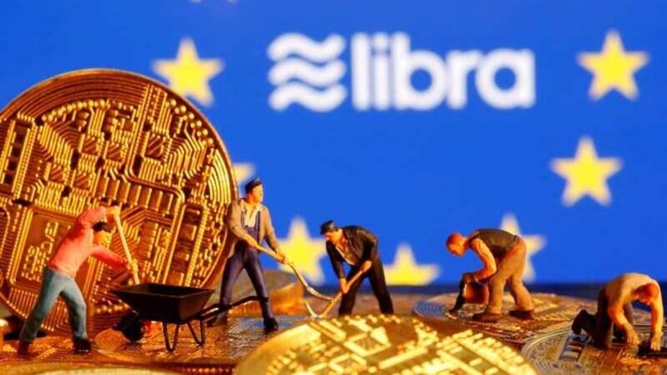 FILE PHOTO: Small toy figures are seen on representations of the virtual currency before the displayed European Union flag and the Facebook Libra logo in this illustration picture, October 20, 2019. REUTERS/Dado Ruvic/Illustration/File Photo