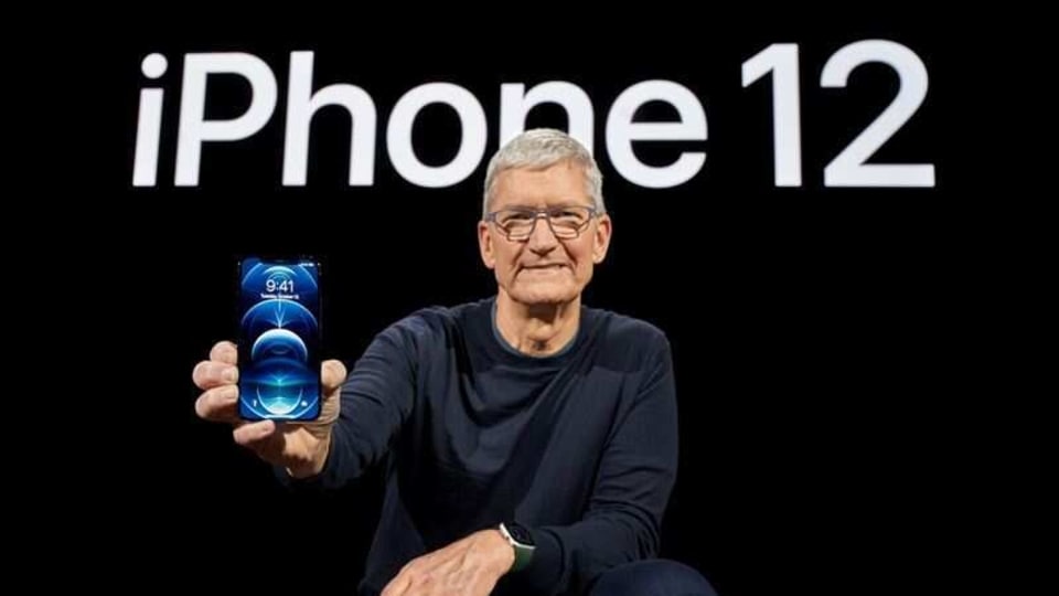 Apple CEO Tim Cook poses with the all-new iPhone 12 Pro at Apple Park in Cupertino, California,