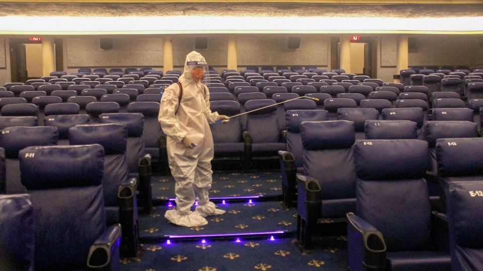 Patiala: A worker sanitizes a theater hall ahead of its re-opening at the Phul Cinema during unlock 5.0, in Patiala, Wednesday, Oct. 14, 2020. (PTI Photo)(PTI14-10-2020_000131A)