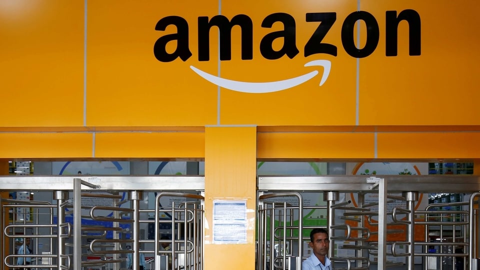 An employee of Amazon walks through a turnstile gate inside an Amazon Fulfillment Centre on the outskirts of Bengaluru, India, September 18, 2018. REUTERS/ Abhishek N. Chinnappa/File Photo