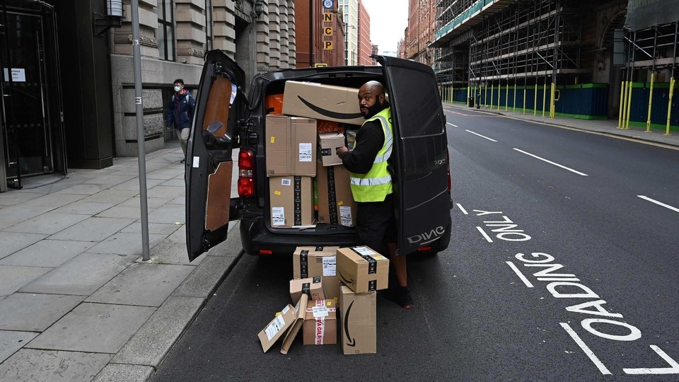 A delivery driver unloads Amazon-branded boxes in Manchester, northwest England. 