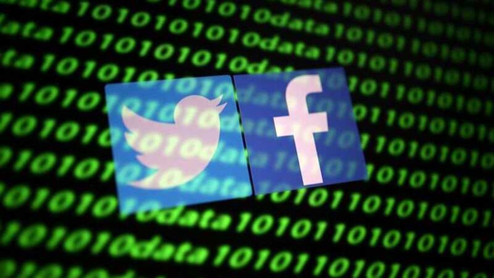 The Twitter and Facebook logo along with binary cyber codes are seen in this illustration taken November 26, 2019. REUTERS/Dado Ruvic/Illustration
