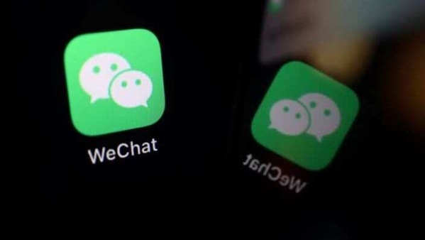 FILE PHOTO: The sign of the WeChat app is seen reflected on a mobile phone in this illustration picture taken September 19, 2020. REUTERS/Florence Lo/Illustration