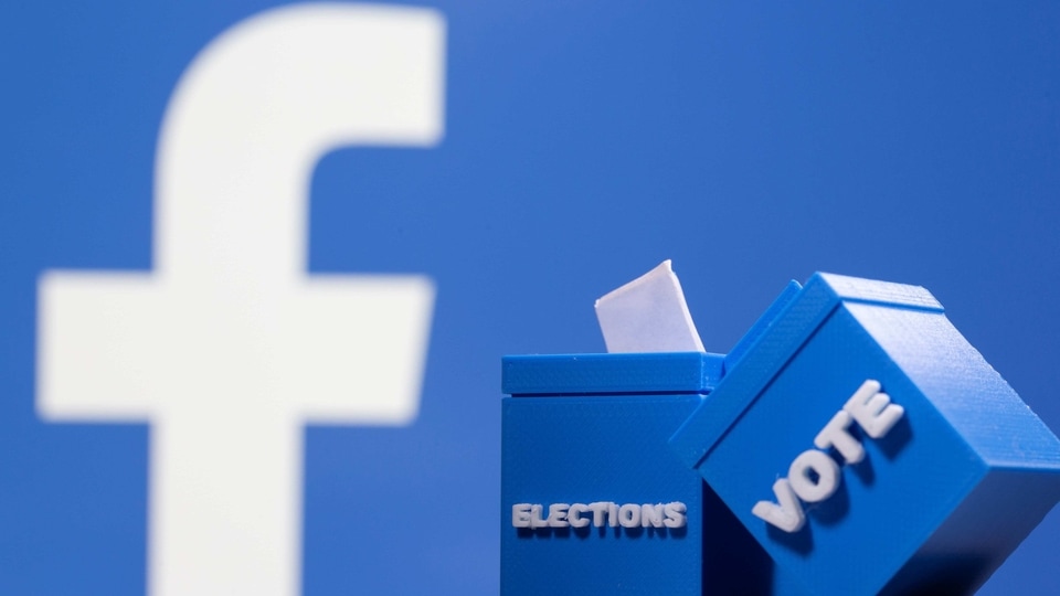 3D printed ballot boxes are seen in front of a displayed Facebook logo in this illustration taken November 4, 2020.