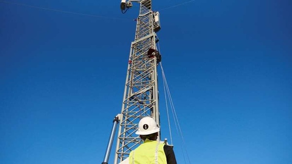 A worker stands in front of a mobile tower in Denver, U.S., August 31, 2020. Picture taken August 31, 2020. DISH NETWORK/Handout via REUTERS  THIS IMAGE HAS BEEN SUPPLIED BY A THIRD PARTY. NO RESALES. NO ARCHIVES MANDATORY CREDIT.