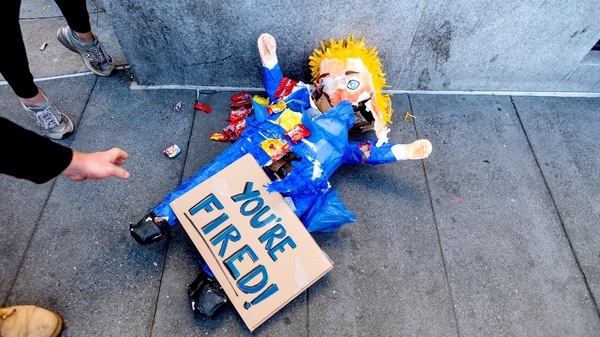 A pinata representing President Donald Trump rests on the ground as several hundred people celebrate the victory of President-elect Joe Biden and Vice President-elect Kamala Harris in San Francisco. 