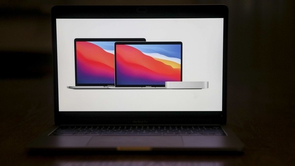 The Apple 13-inch MacBook Pro laptop computer, from left, a 13-inch MacBook Air laptop computer, and a Mac Mini during a virtual product launch in Tiskilwa, Illinois, U.S., on Tuesday, Nov. 10, 2020. Apple Inc.'s MacBook lineup is getting a big jolt, with the introduction of laptops with company's own microchips, technology that is supposed to give the devices faster performance, better battery life and, maybe, bigger profits. Photographer: Daniel Acker/Bloomberg