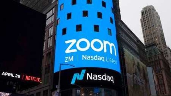 FILE - This April 18, 2019, file photo shows a sign for Zoom Video Communications ahead of the company's Nasdaq IPO in New York. Federal regulators are requiring Zoom to strengthen its security in a proposed settlement of allegations that the video conferencing service misled users about its level of security for meetings. The settlement was announced Monday, Nov. 9, 2020, by the Federal Trade Commission.  (AP Photo/Mark Lennihan, File)