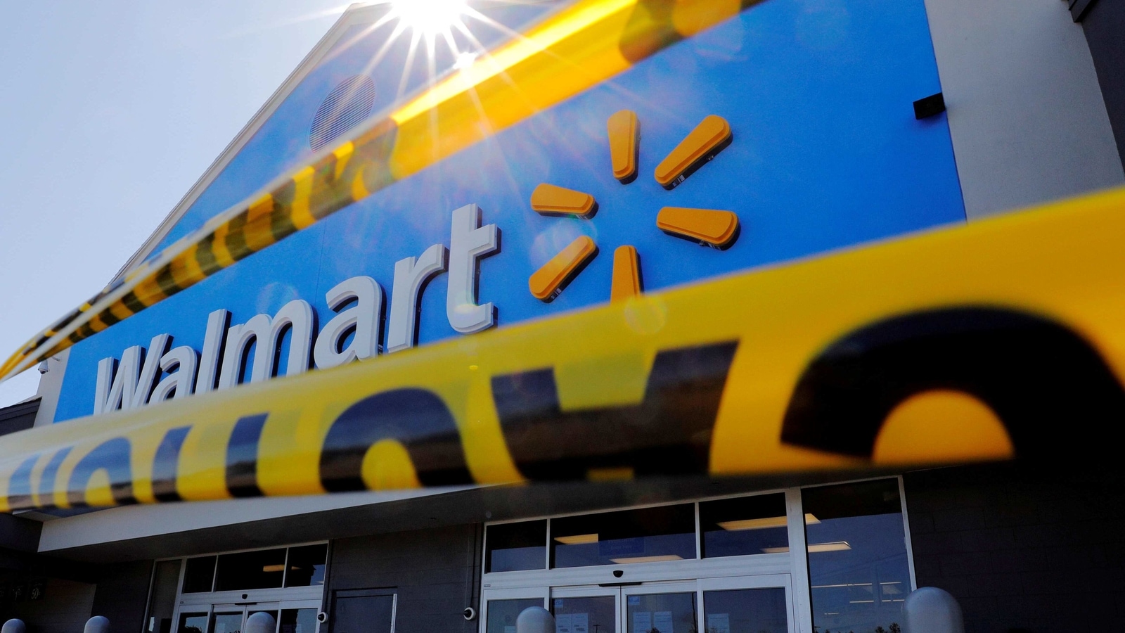 FILE PHOTO: Caution tape hangs at the entrance of a temporarily closed Walmart store in Quincy, Massachusetts, U.S., May 5, 2020.   REUTERS/Brian Snyder/File Photo