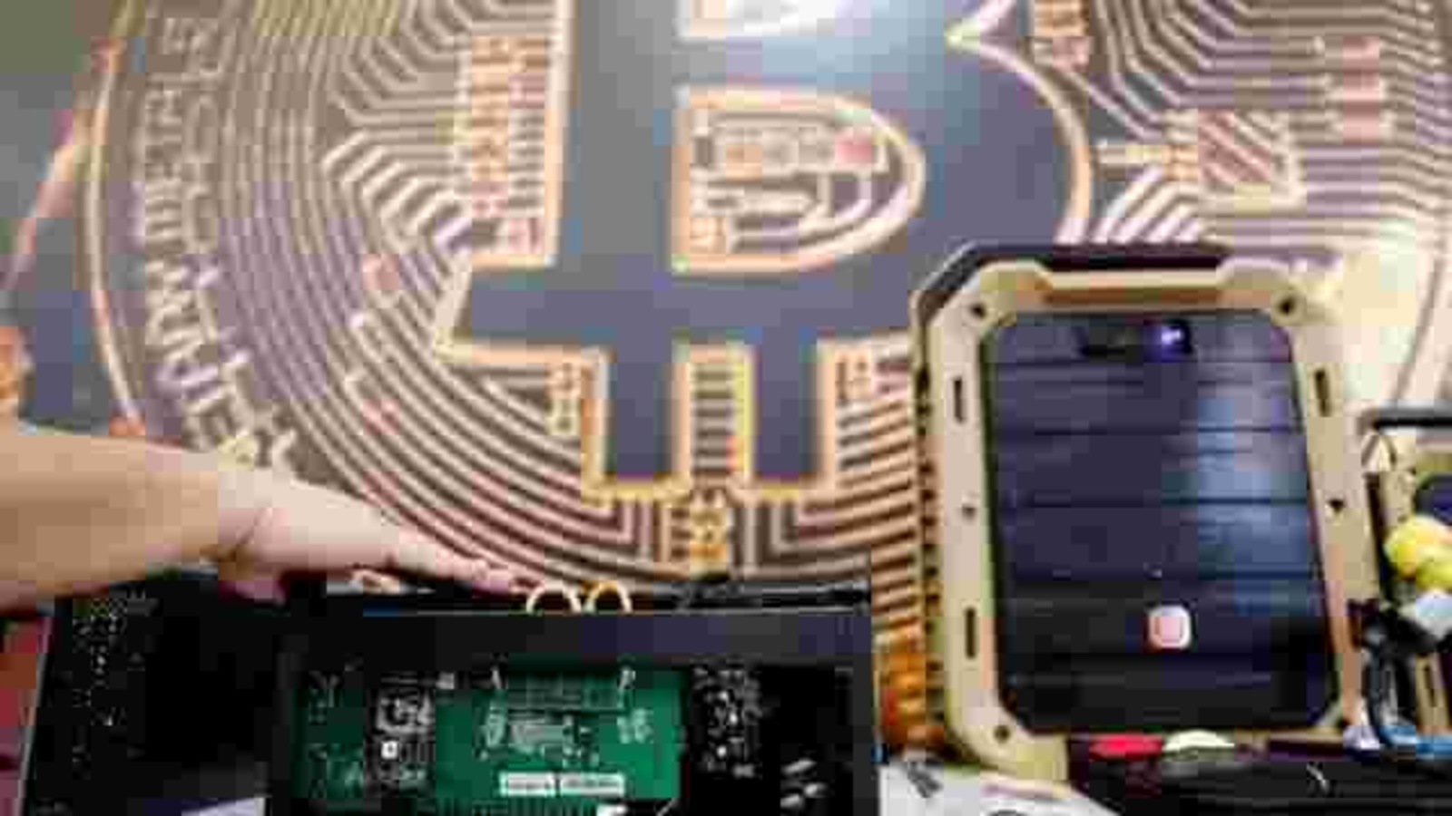 FILE PHOTO: A cryptocurrency mining computer is seen in front of bitcoin logo during the annual Computex computer exhibition in Taipei, Taiwan 