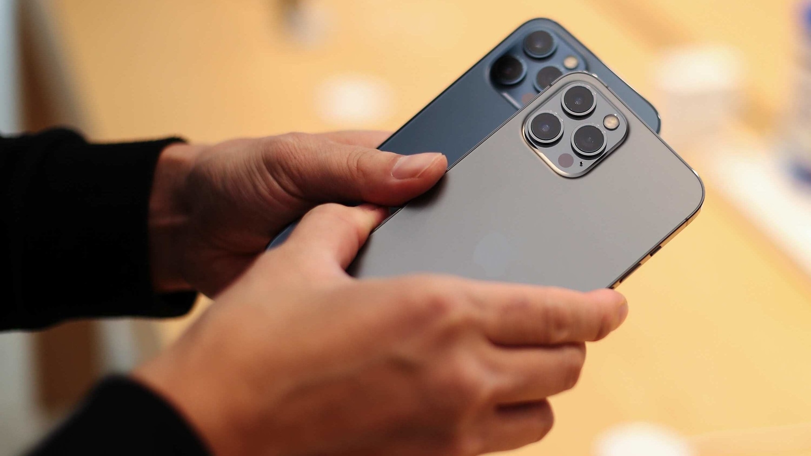 A customer tries out Apple iPhone 12 Pro Max at the Apple flagship store during a product launch event in Sydney, Australia. 