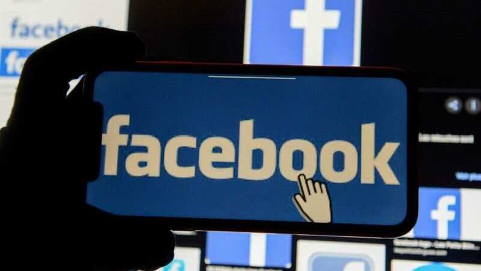 FILE PHOTO: The Facebook logo is displayed on a mobile phone in this picture illustration taken December 2, 2019. REUTERS/Johanna Geron/Illustration