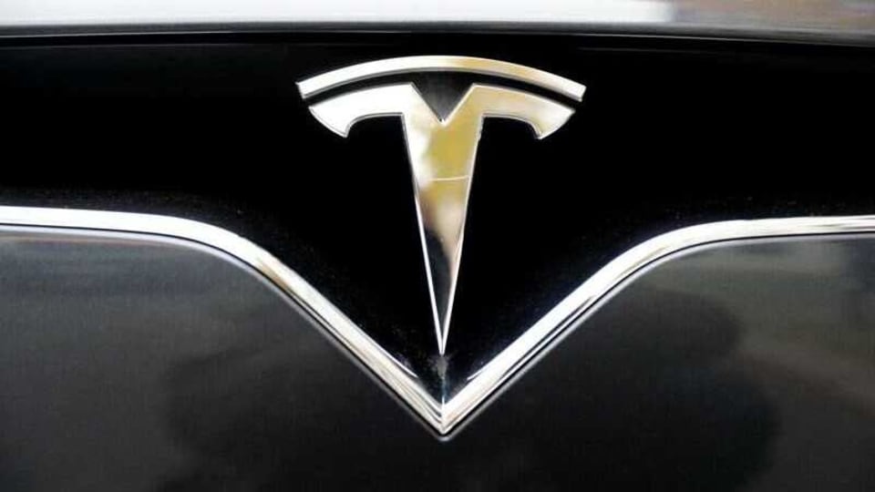 FILE PHOTO: The company logo is pictured on a Tesla Model X electric car in Berlin, Germany, November 13, 2019.    REUTERS/Fabrizio Bensch/File Photo