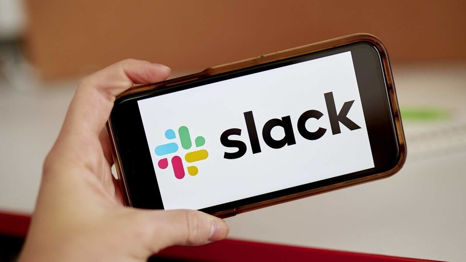 Slack signage on a smartphone in the Brooklyn Borough of New York, U.S., on Tuesday, Dec. 1, 2020. Salesforce.com's expected purchase of Slack Technologies Inc. will likely be valued in the high $20 billions, according to the WSJ. Photographer: Gabby Jones/Bloomberg