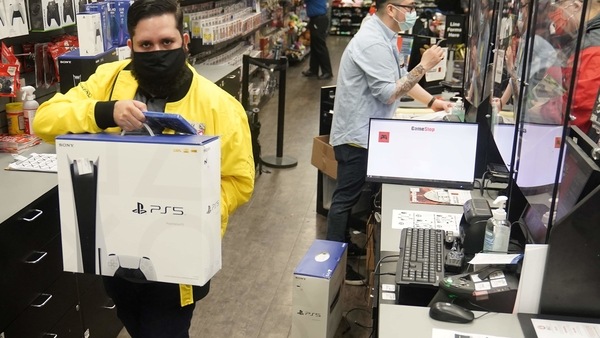 Inside a GameStop store a worker takes a Sony PS5 gaming console to the counter to sell in the Manhattan borough of New York City, New York, U.S., November 12, 2020. REUTERS/Carlo Allegri