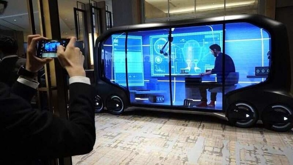 Toyota’s e-Palette is a largely transparent, driverless oblong carriage on wheels that’s powered by a battery. It can accommodate up to 20 passengers, with seats that fold up and allow the space to be re-purposed.