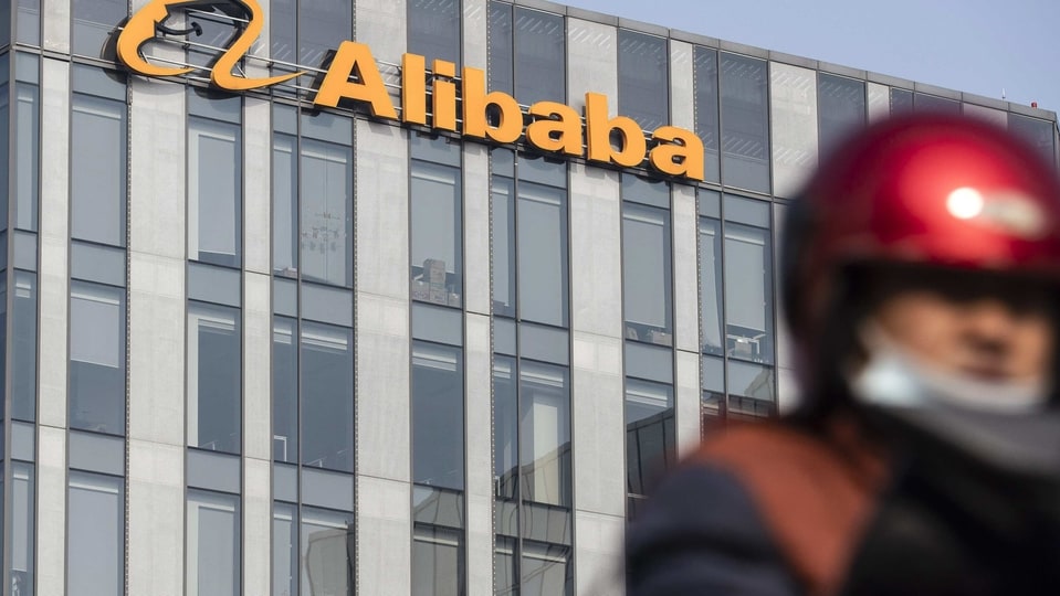 A motorist travels past an Alibaba Group Holding Ltd. office building in Shanghai, China, on Thursday, Dec. 24, 2020. China kicked off an investigation into alleged monopolistic practices at Alibaba and summoned affiliate Ant Group Co. to a high-level meeting over financial regulations, escalating scrutiny over the twin pillars of billionaire Jack Ma�s internet empire. Photographer: Qilai Shen/Bloomberg