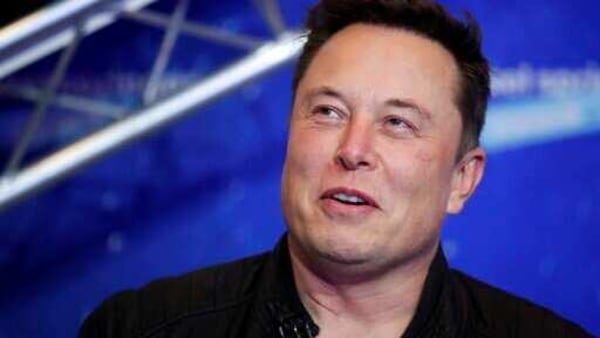 FILE - In this Tuesday, Dec. 1, 2020, file photo, SpaceX owner and Tesla CEO Elon Musk arrives on the red carpet for the Axel Springer media award, in Berlin. In a tweet Tuesday, Dec. 22, 2020, Musk said he once considered selling the electric car maker to Apple, but the iPhone maker’s CEO Tim Cook blew off the meeting. (Hannibal Hanschke/Pool Photo via AP, File)