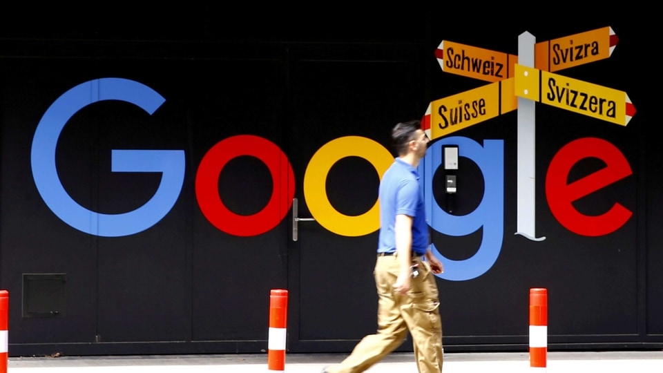 FILE PHOTO: A man walks past a logo of Google in front of at an office building in Zurich, Switzerland July 1, 2020.   REUTERS/Arnd Wiegmann/File Photo