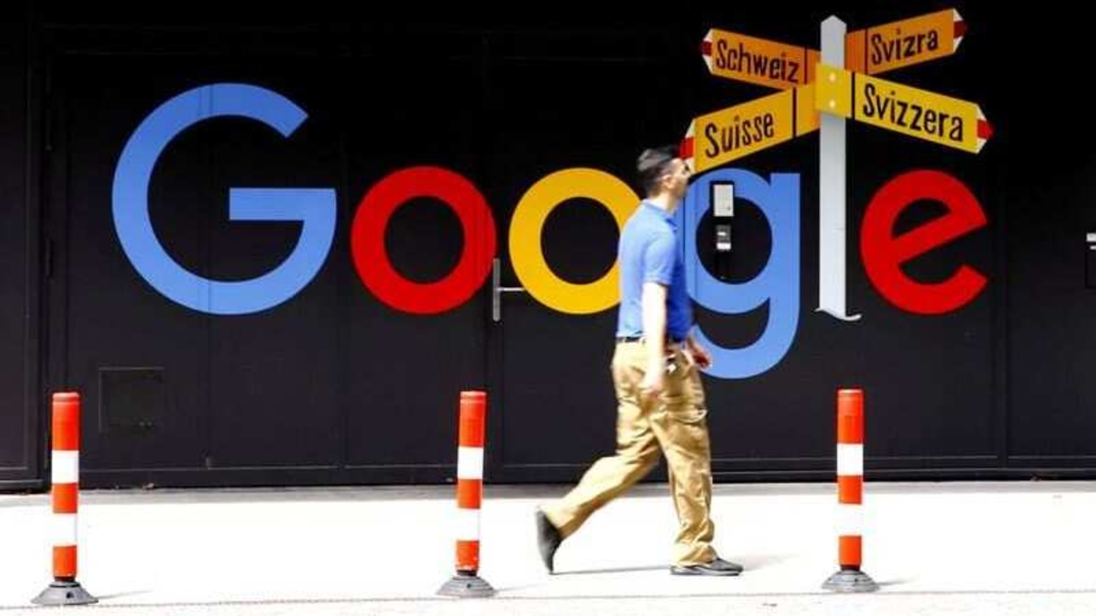 FILE PHOTO: A man walks past a logo of Google in front of at an office building in Zurich, Switzerland July 1, 2020.   REUTERS/Arnd Wiegmann/File Photo