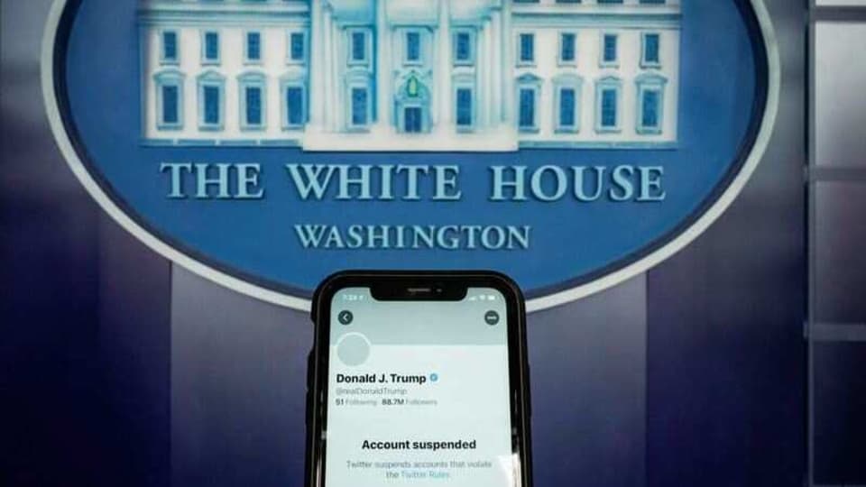 A photo illustration shows the suspended Twitter account of U.S. President Donald Trump on a smartphone at the White House briefing room in Washington, U.S., January 8, 2021.  REUTERS/Joshua Roberts/Illustration