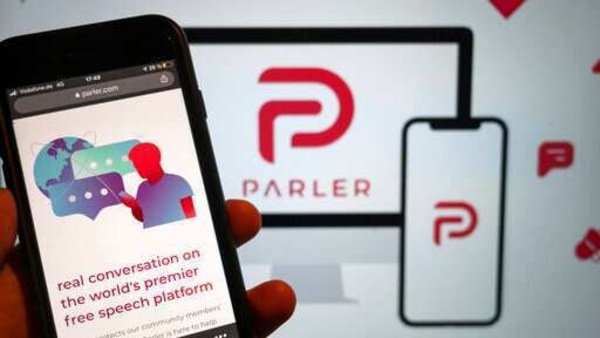 The conservative-friendly social network Parler was booted off the internet Monday, Jan. 11, over ties to last week's siege on the U.S. Capitol, but not before hackers made off with an archive of its posts, including any that might have helped organize or document the riot. (Christophe Gateau/dpa via AP)
