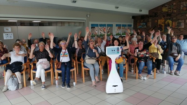 In this undated image courtesy of CareClever SAS, a group of elderly French people learns about the Cutii robot for use in their homes. 