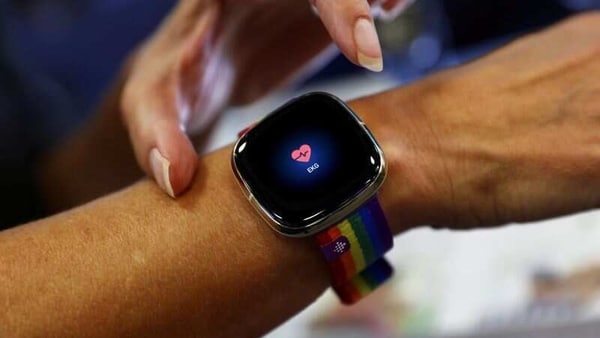 An employee uses an electrocardiogram function on a Fitbit smartwatch at the IFA consumer technology fair, amid the coronavirus disease (COVID-19) outbreak, in Berlin, Germany September 3, 2020. 