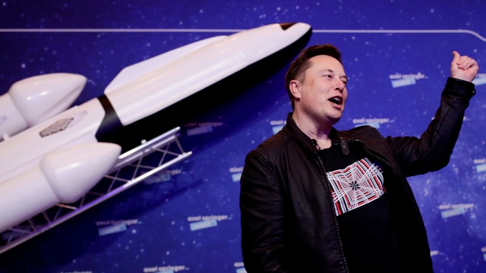 FILE PHOTO: SpaceX owner and Tesla CEO Elon Musk gestures after arriving on the red carpet for the Axel Springer award, in Berlin, Germany, December 1, 2020. REUTERS/Hannibal Hanschke/File Photo