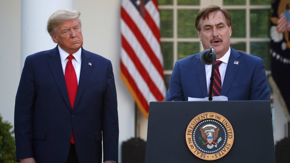 In this March 30, 2020 file photo, My Pillow CEO Mike Lindell speaks as President Donald Trump listens during a briefing about the coronavirus in the Rose Garden of the White House, in Washington. 