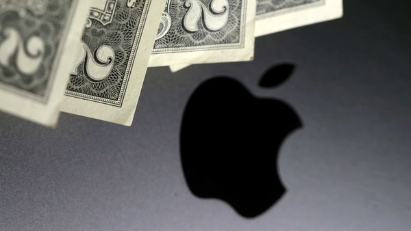 FILE PHOTO: U.S. dollar banknotes are seen in front of the Apple logo in this photo illustration taken August 3, 2018. REUTERS/Dado Ruvic/Illustration/File Photo