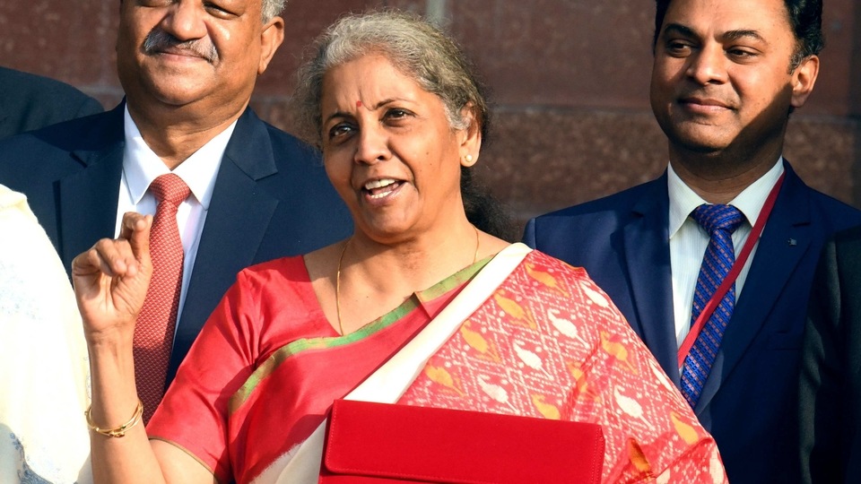 Union Minister for Finance and Corporate Affairs, Nirmala Sitharaman shows the Made-in-India tab through which budget will be presented as she leaves from the Ministry of Finance to present the Union Budget 2021-22 in the Parliament, in New Delhi on Monday.