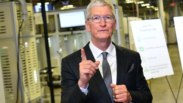 (FILES) In this file photo taken on November 20, 2019 Apple CEO Tim Cook speak to the press during a tour of the Flextronics computer manufacturing facility, with US President Donald Trump, where Apple's Mac Pros are assembled in Austin, Texas. - Apple chief Tim Cook says he wants those involved with the deadly attack on the US Capitol last week to be held accountable, even if that includes US President Donald Trump.
