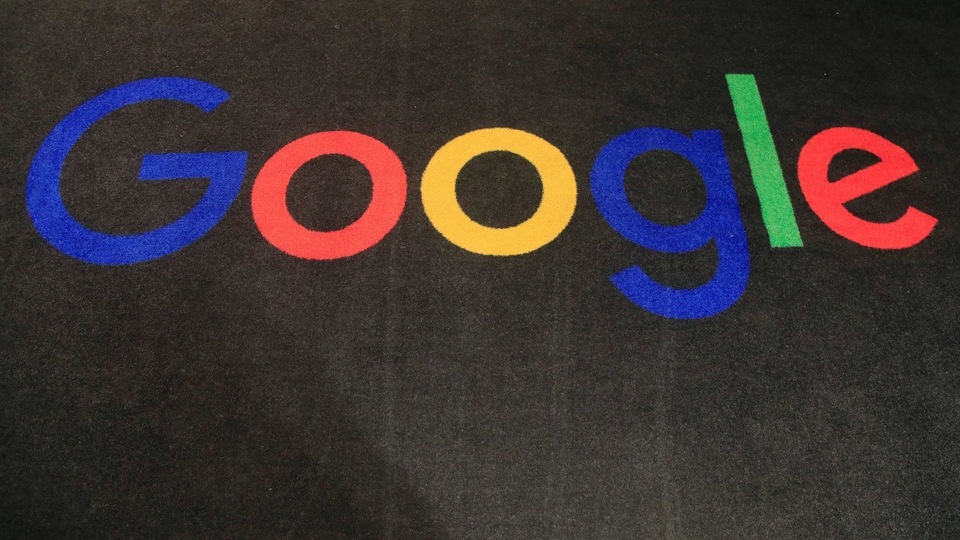 FILE - In this Monday, Nov. 18, 2019, file photo, the logo of Google is displayed on a carpet at the entrance hall of Google France in Paris. In a settlement announced Monday, Feb. 1, 2021, Google will pay $2.6 million to more than 5,500 employees and past job applicants to resolve allegations that the internet giant discriminated against female engineers and Asians in California and Washington state. (AP Photo/Michel Euler, File)