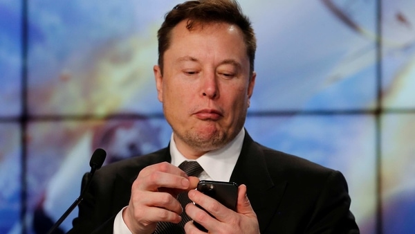 FILE PHOTO: SpaceX founder and chief engineer Elon Musk looks at his mobile phone during a post-launch news conference to discuss the  SpaceX Crew Dragon astronaut capsule in-flight abort test at the Kennedy Space Center in Cape Canaveral, Florida, U.S. January 19, 2020. REUTERS/Joe Skipper/File Photo