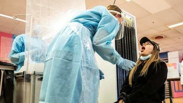 A health worker in protective suite takes a swab sample from a patient to be tested for the coronavirus disease (COVID-19) at Herlev Hospital in Copenhagen, Denmark.