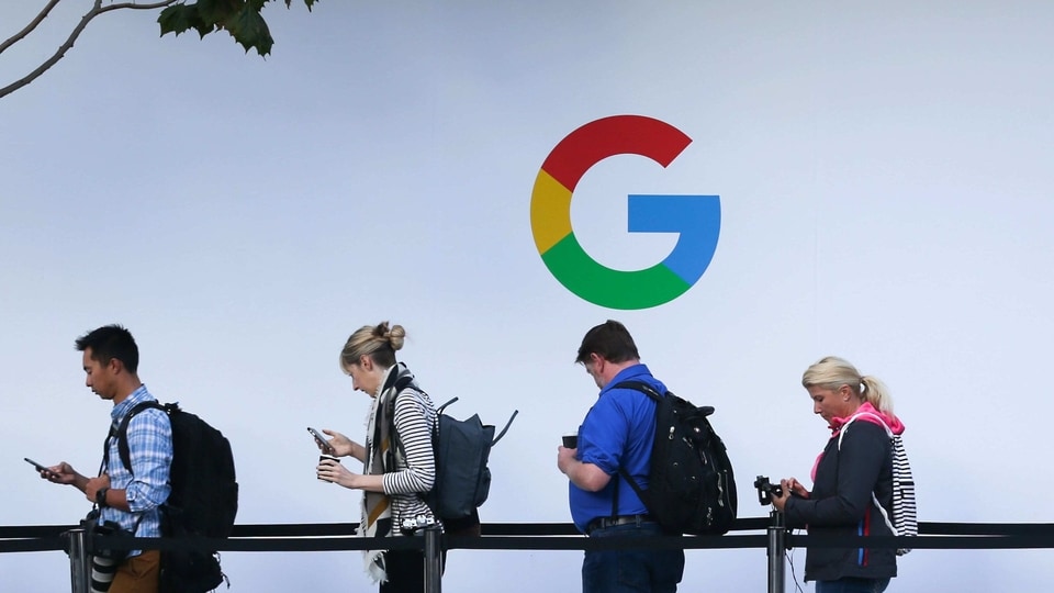 (FILES) In this file photo taken on October 4, 2017, attendees wait in line to enter a Google product launch event at the SFJAZZ Center in San Francisco, California. - Google parent Alphabet on February 2, 2021, reported that its quarterly profit rocketed some 50 percent to $15.2 billion at the end of last year as its digital ad business thrived. (Photo by Elijah Nouvelage / AFP)