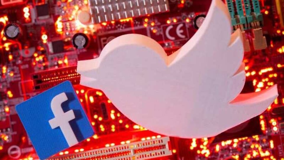 FILE PHOTO: 3D printed Facebook and Twitter logos are placed on a computer motherboard in this illustration taken January 21, 2021. REUTERS/Dado Ruvic/Illustration/File Photo