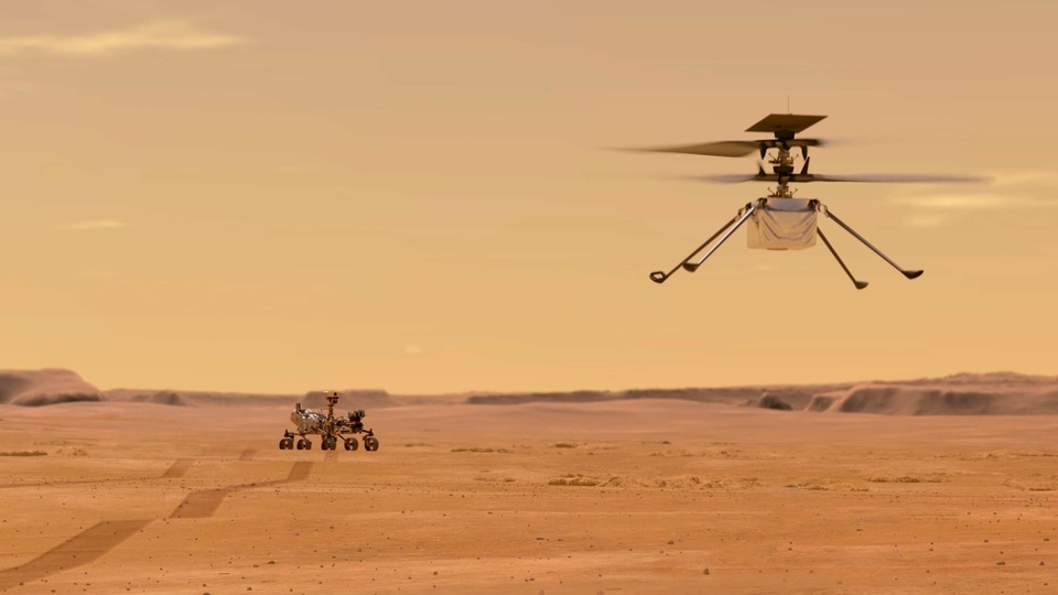 This illustration made available by NASA depicts the Ingenuity helicopter on Mars after launching from the Perseverance rover, background left. It will be the first aircraft to attempt controlled flight on another planet. (NASA/JPL-Caltech via AP)