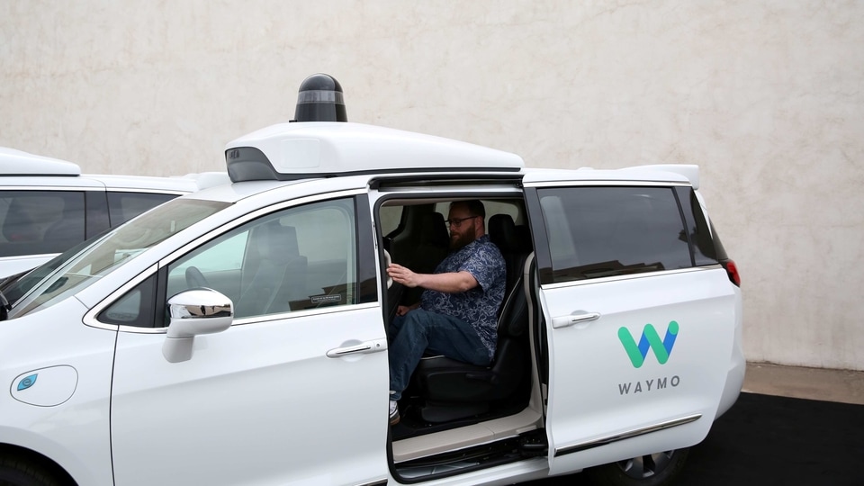 Early rider Alex Hoffman seen inside a Waymo self-driving vehicle, during a demonstration in Chandler, Arizona, (File photo)