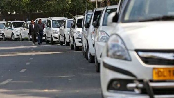 Drivers of Uber and Ola walk next to their parked vehicle's during a protest in New Delhi, India, February 14, 2017. REUTERS/Adnan Abidi/File Photo
