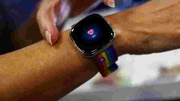 An employee uses an electrocardiogram function on a Fitbit smartwatch at the IFA consumer technology fair, amid the coronavirus disease (COVID-19) outbreak, in Berlin, Germany.