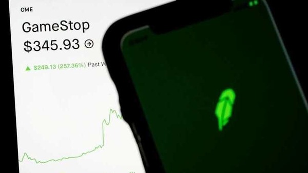FILE PHOTO: Trading information for GameStop is displayed on the Robinhood App as another screen displays the Robinhood logo in this photo illustration January 29, 2021. REUTERS/Brendan McDermid/Illustration/File Photo