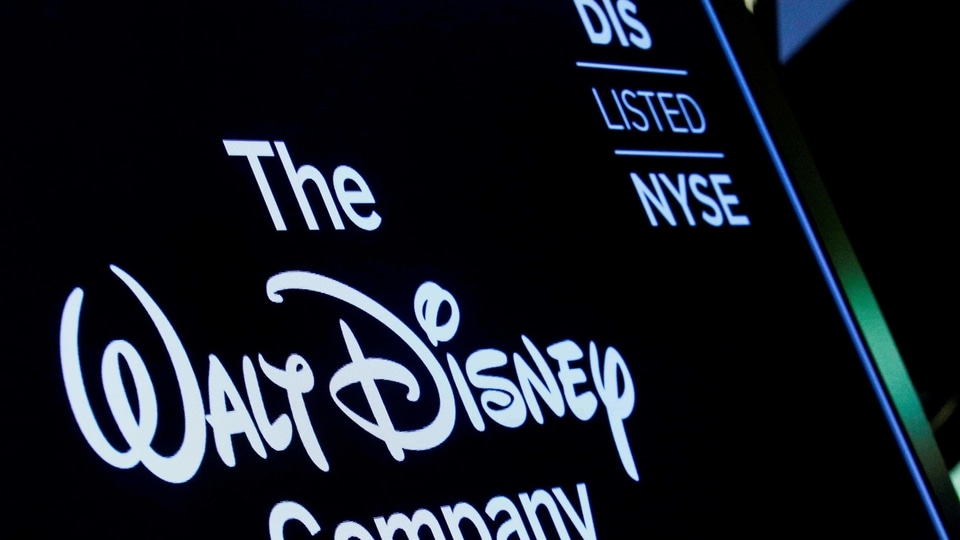 A screen shows the logo and a ticker symbol for The Walt Disney Company on the floor of the New York Stock Exchange (NYSE).